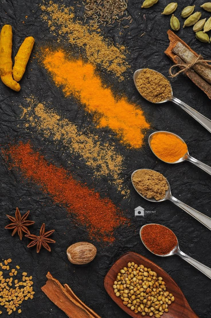 Spice powders on a dark board